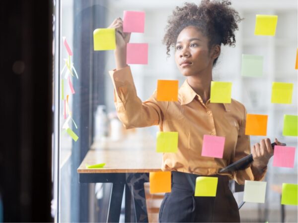 Employee brainstorming in her office