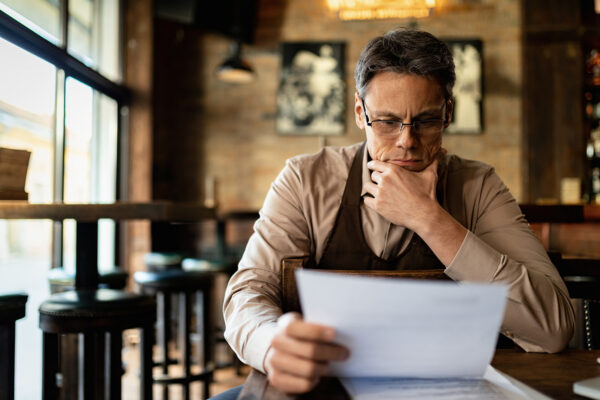 Business owner reading through paperwork