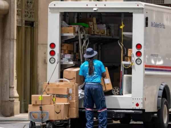 usps postal worker loading delivery truck