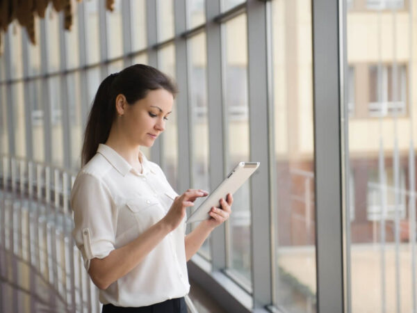 government employee reviewing tablet device office corridor