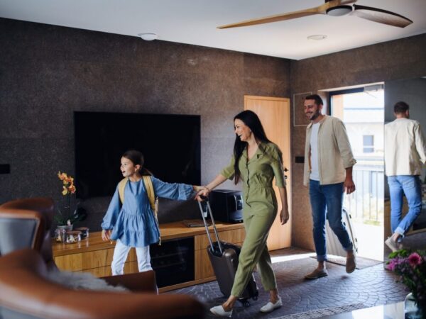 family arriving short term vacation rental with luggage