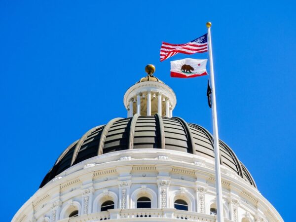 California state capitol dome American bear flag blue sky