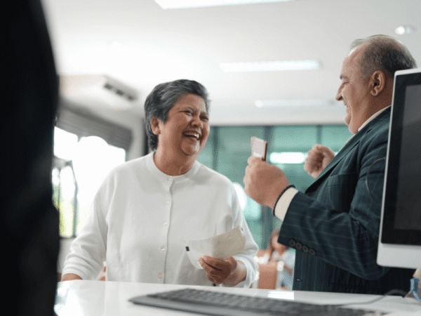 customer smiling at service counter with staff