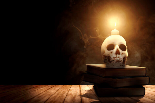 Skull candle on top of books